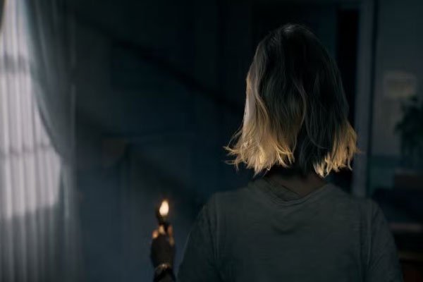Grace Ashcroft navigates darkness with only a lighter in hand, emphasizing Resident Evil 9’s shift toward vulnerability and atmosphere over firepower.