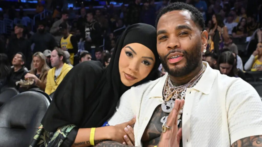 Brittany Renner and Kevin Gates sitting courtside at a Los Angeles Lakers game on April 22, 2025, looking relaxed and smiling.